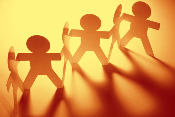 istock Paper chain team holding hands 905339248