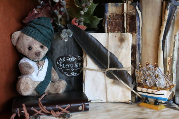 istock retro toy bear and old book 905347398