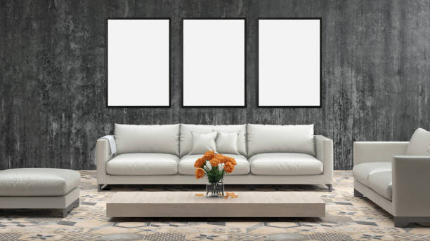 istock Three blank picture frames on gray wall with sofa in front of it 905347582