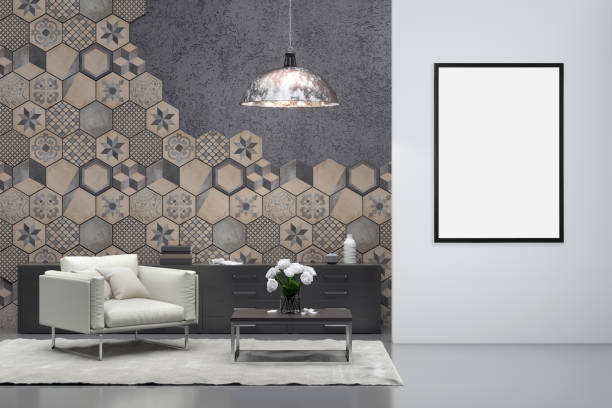 istock Blank picture frame on gray wall with armchair in front 905347636