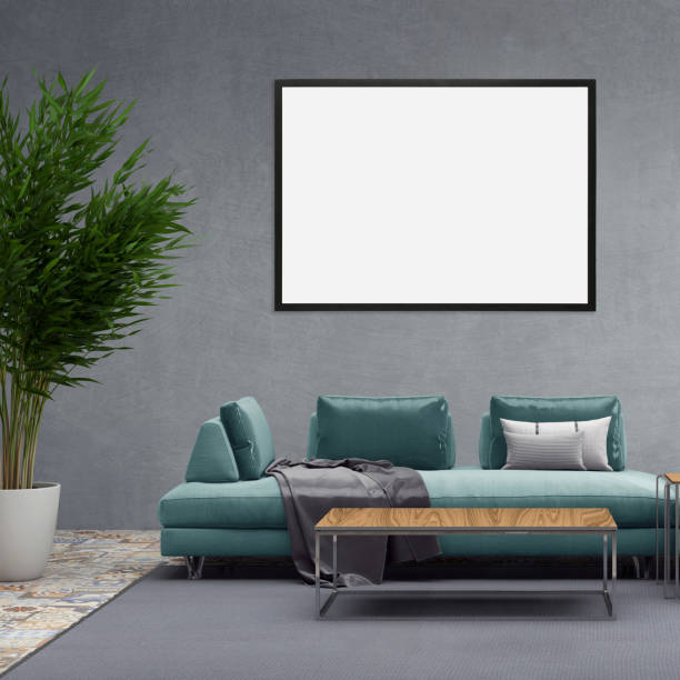 istock Blank picture frame on gray wall with sofa in front of it 905347648