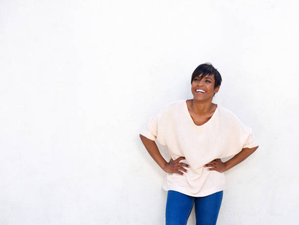 istock Young african american lady laughing against white wall with copy space 905348124