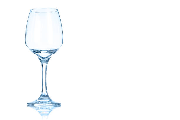 istock Empty glass of red wine toned in blue color. 905348546