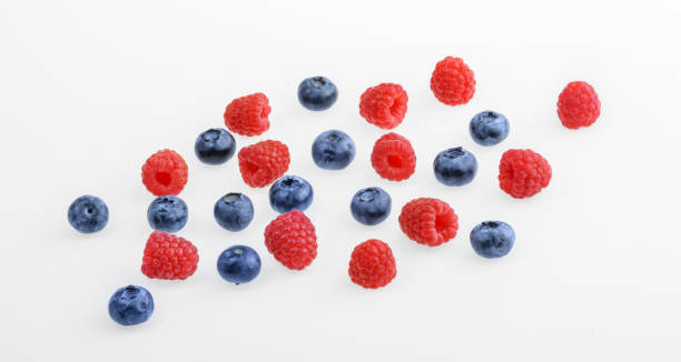 istock Raspberries and blueberries on white background.  top view 905351406