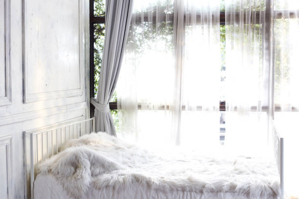 istock white bedroom with window and curtain 905355156