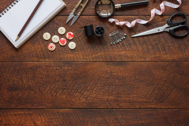 istock Top view aerial image fashion designer background concept.Flat lay sewing accessory or tailor tool work shop on modern rustic brown wooden at home office desk studio.Space for creative design mock up. 905357406