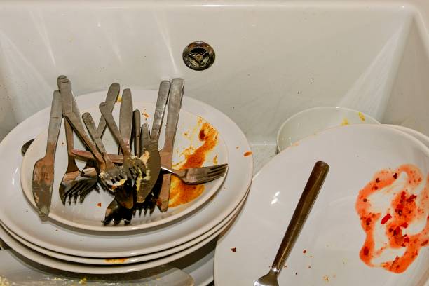 istock Dirty dishes and cutlery in a kitchen sink. 905358728