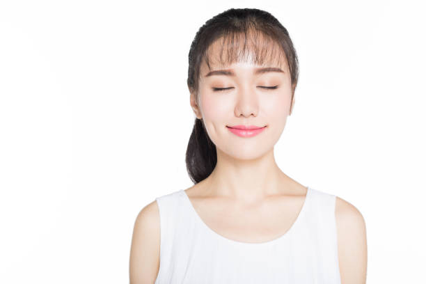 istock young woman smiling with eyes closed 905364918
