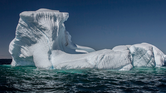 Iceberg melting in the sun  giving it many shapes, Fogo, Newfoundland, Canada