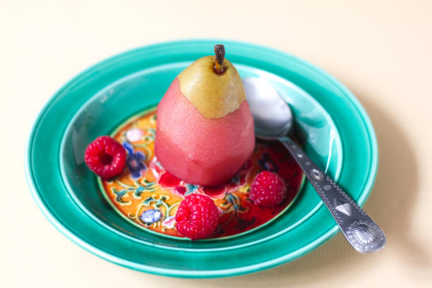 Poached Pear in Wine Dessert on Green Plate