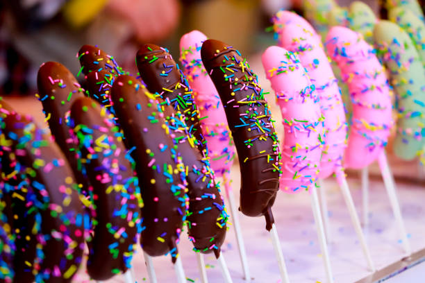 bananas covered with dark chocolate with rainbow sprinkles Selective focus
