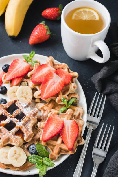 istock Waffles with berry fruit and cup of green tea 905386970