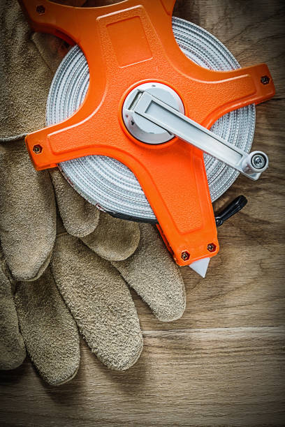istock Protective gloves measuring tape on wooden board 905390638