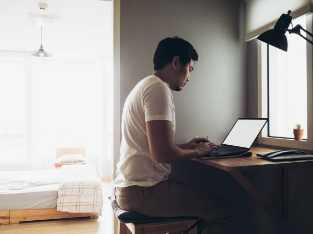 istock Freelance man is working on laptop in his apartment. 905393154