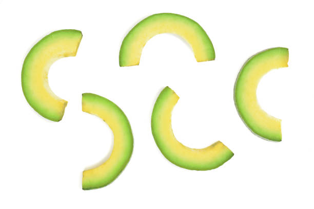 istock avocado slices isolated on white background. Top view. Flat lay pattern 905393420