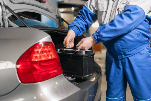 Engine engineer is replacing car battery because car battery is depleted. concept car maintenance Engine engineer is replacing car battery because car battery is depleted. concept car maintenance. Combing stock pictures, royalty-free photos & images