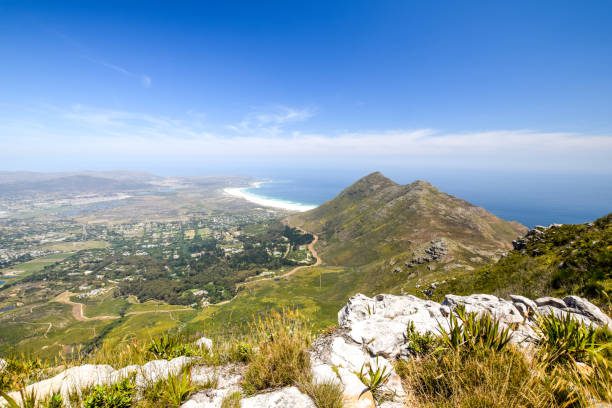 Panoramic view of Noordhoek, a suburb of Cape Town, South Africa, located below Chapman's Peak on the west coast of the Cape Peninsula, and Noordhoek Long Beach. Seen from Silvermine Nature Reserve. Panoramic view of Noordhoek, a suburb of Cape Town, South Africa, located below Chapman's Peak on the west coast of the Cape Peninsula, and Noordhoek Long Beach. Seen from Silvermine Nature Reserve. chapmans peak drive stock pictures, royalty-free photos & images