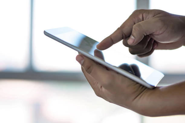 istock man touch tablet, laptop connecting wifi technology business people workspace 905397674