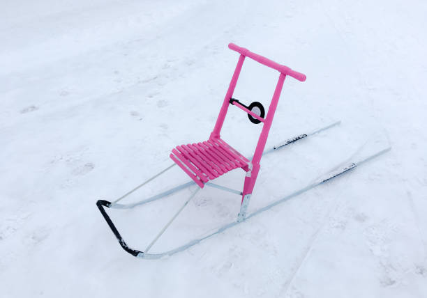 Young child is experiencing exciting sledding adventure on snow-covered slope, creating motion blur, having winter fun.