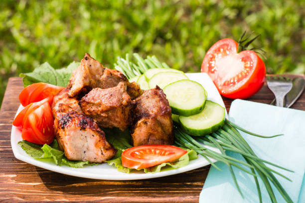 istock Barbecue on a plate with vegetables on a wooden table 905410146