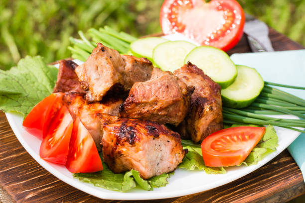istock Barbecue on a plate with cucumbers and tomatoes 905410148