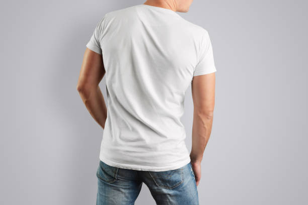 istock Mockup  white T-shirt with a back view on a muscular man with blue jeans 905413650