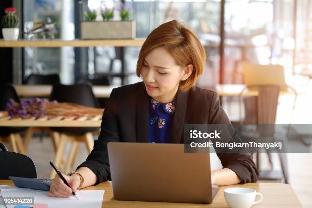 Cropped Shot Of A Young Asian Businesswoman Making Notes In Cafe Stock Photo - Download Image Now