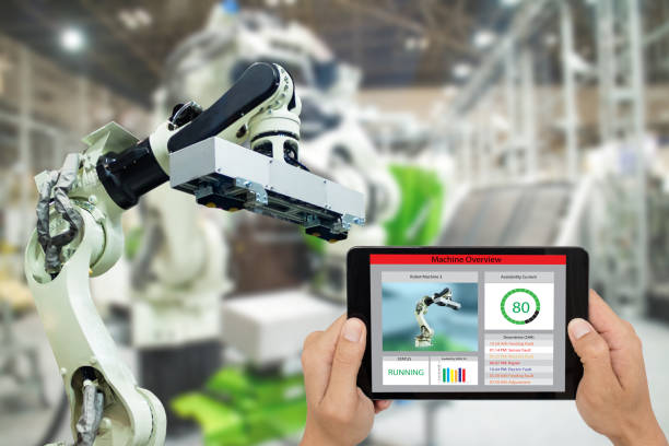 istock iot industry 4.0 concept,industrial engineer using software (augmented, virtual reality) in tablet to monitoring machine in real time.Smart factory use Automation robot arm in automotive manufacturing 905416756