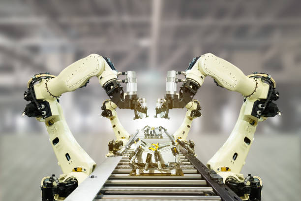 istock iot industry 4.0 technology concept.Smart factory using trending automation robotic arms with empty conveyor belt in operation line. Automotive manufacturing use it for precision, Repetition, intense 905416760