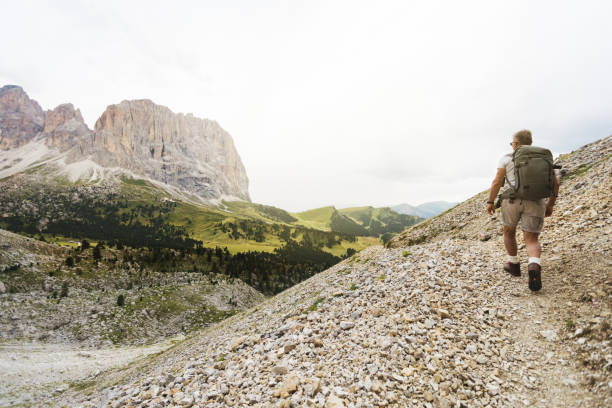 istock Senior man trail hiking on the mountain 905420284