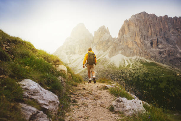Senior man trail hiking on high mountain on the Alps, Dolomites sector.