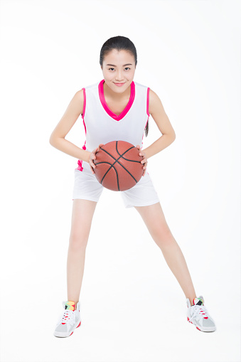 young woman with basketball over white background.