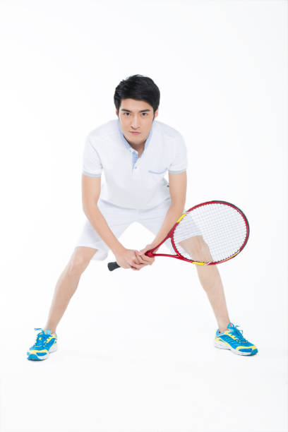 istock young man playing tennis over white background 905422280