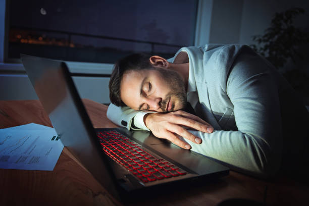istock Businessman sleeping on a laptop, working at night, overworking 905428554