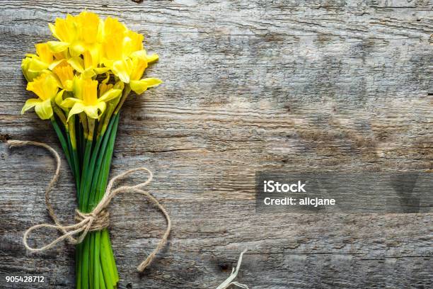 Spring Background Easter Daffodils Bouquet On Wooden Table Stock Photo - Download Image Now