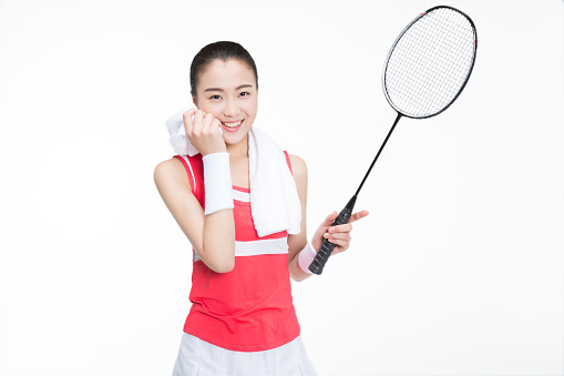 female badminton player wiping sweat with towel.