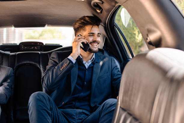 giovane uomo d'affari in limousine - driving mobile phone car talking foto e immagini stock