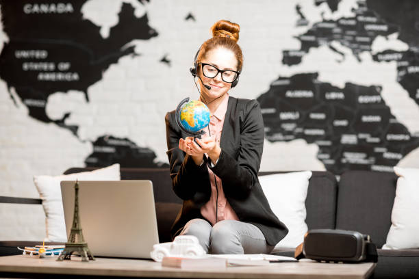istock Travel agent portrait on the world map background 905432528