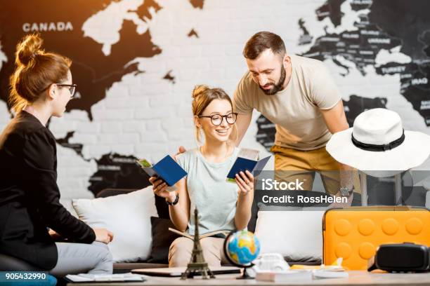 Couple At The Travel Agency Office Stock Photo - Download Image Now - Couple - Relationship, 20-29 Years, Adult