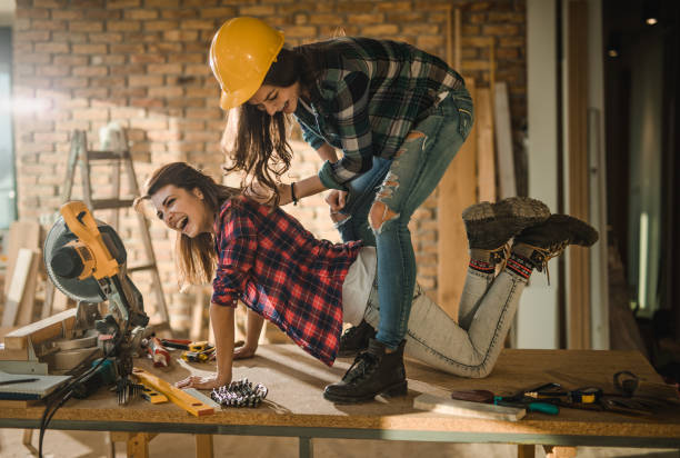 istock Cheerful female workers having fun on the table at construction site. 905433310