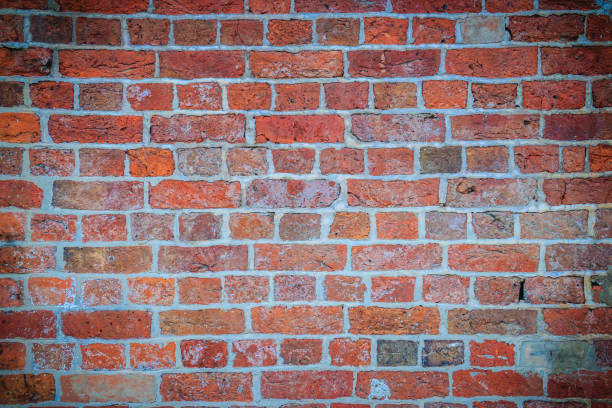 istock Abstract red brick old wall texture background. Ruins uneven crumbling red brick wall background texture. 905433560