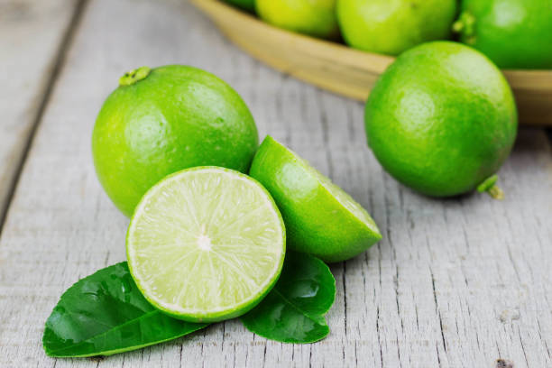 istock Lime slices on wooden. 905435106