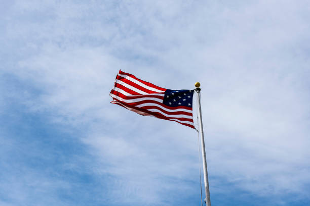 istock American Flag on the blue sky. 905435434