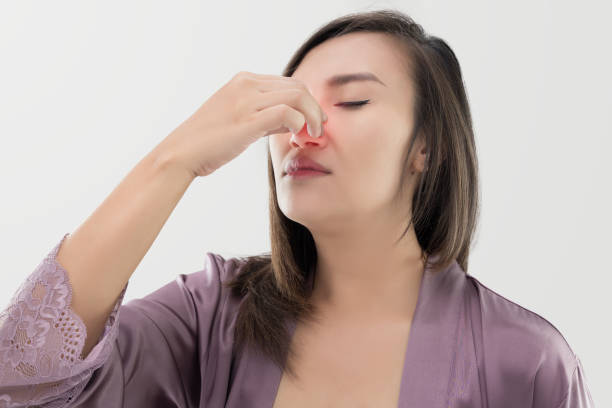 Thai women with nosebleed Asian women in satin nightwear with nosebleed against gray background, The asian people hurts her nose Nasal Polyps stock pictures, royalty-free photos & images