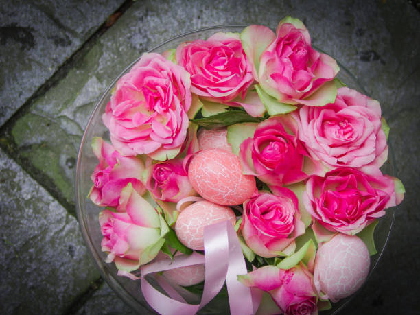 istock Easter bouquet of pink eggs and pink roses. 905444292