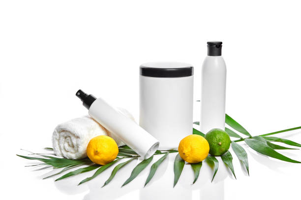 istock White bottles and two whole lemon and lime isolated on white background. The concept for advertising cosmetics 905444854