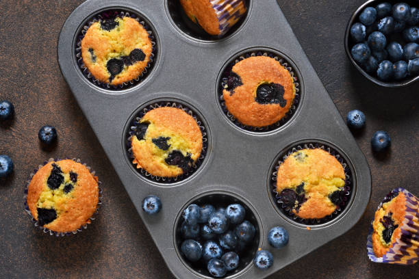 istock Homemade vanilla muffins with blueberries on a dark concrete background.Rustic! 905449798