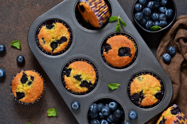 istock Homemade vanilla muffins with blueberries on a dark concrete background.Rustic! 905450002