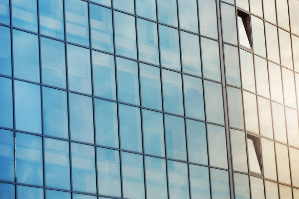 istock sky and clouds reflected in the windows of a modern office building, glass building 905453228