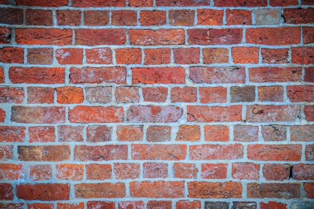 istock Abstract red brick old wall texture background. Ruins uneven crumbling red brick wall background texture. 905453294